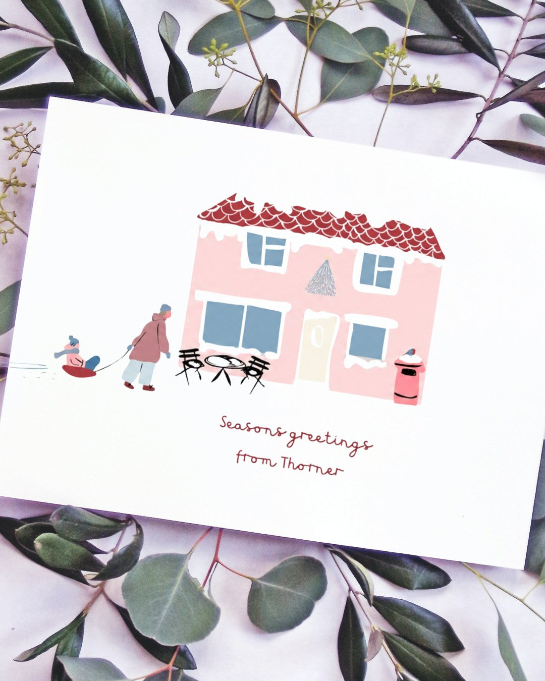 Thorner Christmas card with a pink house and festive figures illustration